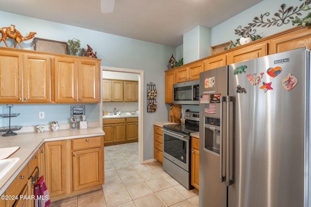 kitchen with light tile patterned floors and stainless steel appliances