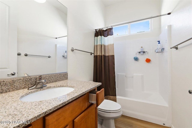 full bathroom with hardwood / wood-style flooring, vanity, shower / tub combo, and toilet