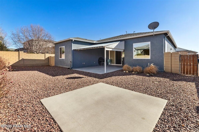 rear view of property featuring a patio area