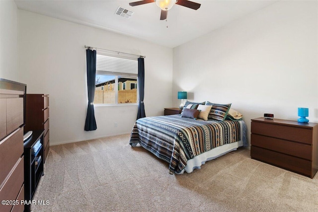 bedroom with ceiling fan and light colored carpet