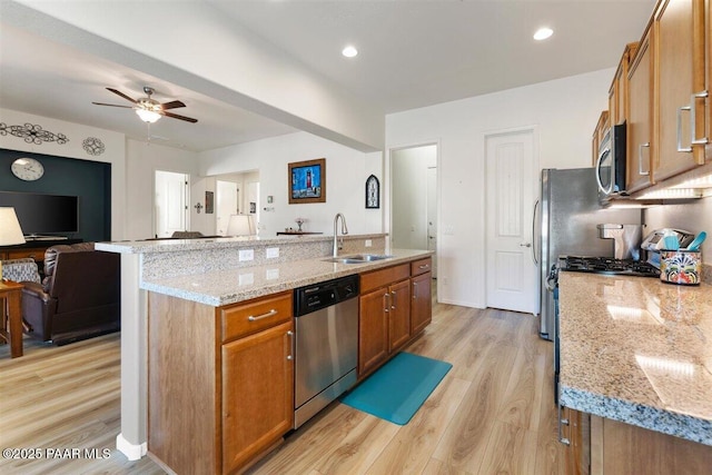 13014 E Vega St, Dewey-Humboldt, AZ 86327 - kitchen with stainless steel appliances, open floor plan, brown cabinets, light wood-type flooring, and recessed lighting