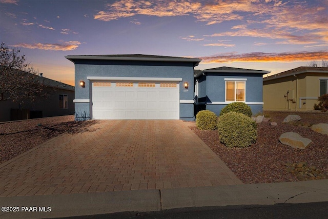 13014 E Vega St, Dewey-Humboldt, AZ 86327 - view of front facade featuring stucco siding, decorative driveway, and a garage