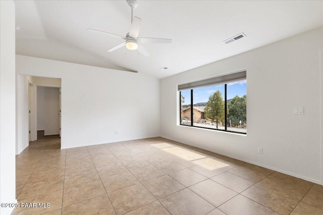 spare room featuring visible vents, ceiling fan, light tile patterned flooring, and vaulted ceiling