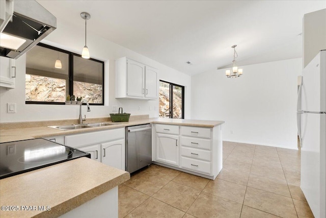 kitchen featuring under cabinet range hood, a sink, freestanding refrigerator, a peninsula, and dishwasher