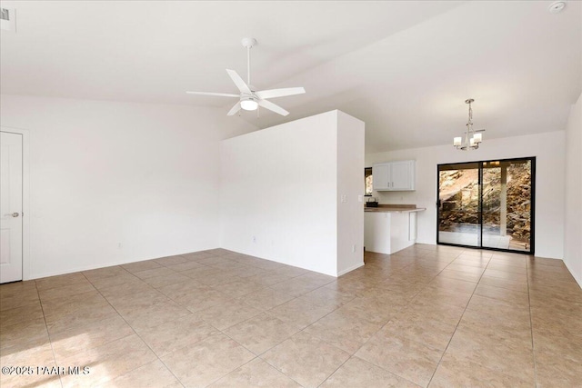 unfurnished living room with lofted ceiling and ceiling fan with notable chandelier