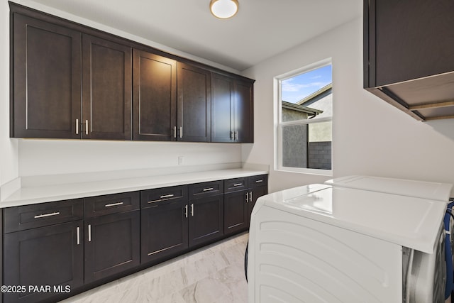 washroom featuring cabinets and washer and dryer