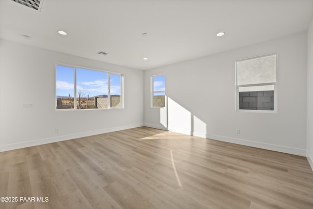 spare room with light hardwood / wood-style flooring