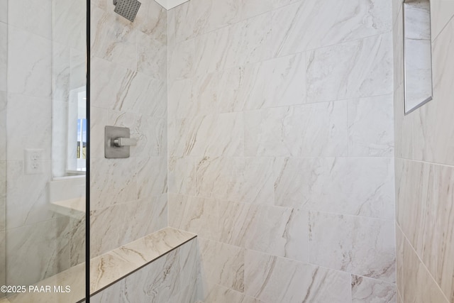 bathroom with a tile shower