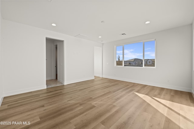 spare room featuring light hardwood / wood-style flooring