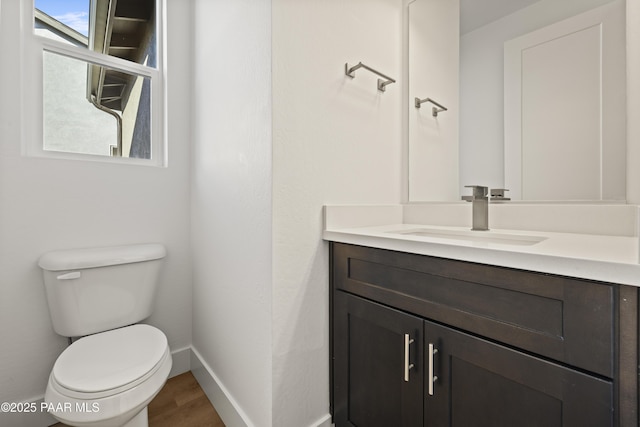 bathroom featuring hardwood / wood-style floors, vanity, and toilet