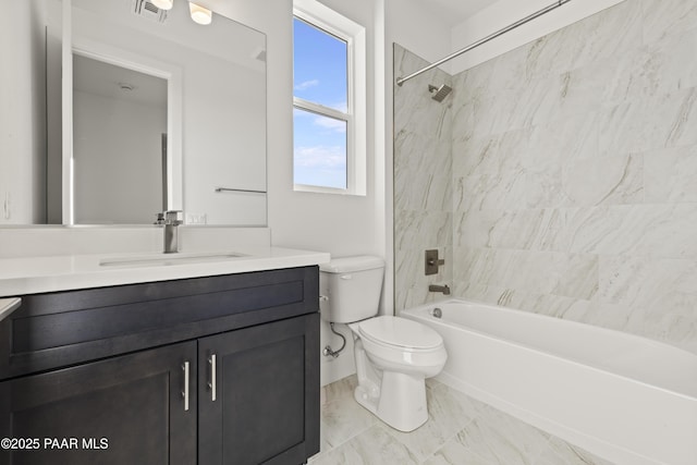 full bathroom with vanity, tiled shower / bath combo, and toilet