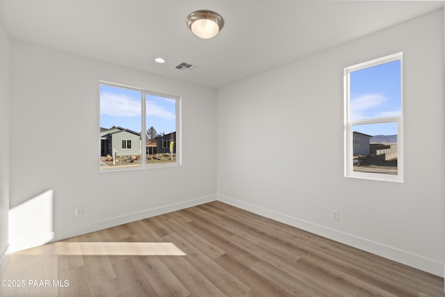 empty room with light hardwood / wood-style flooring