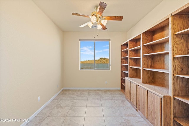 spare room featuring light tile patterned floors and ceiling fan