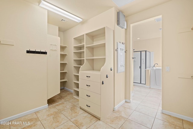 spacious closet with light tile patterned floors