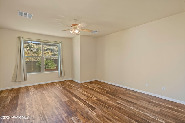 empty room with hardwood / wood-style floors and ceiling fan