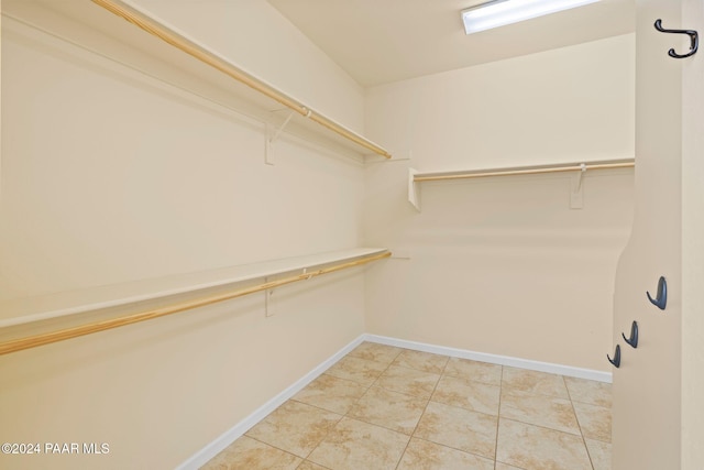 spacious closet featuring tile patterned flooring