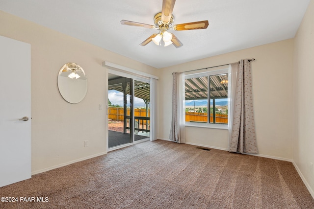 spare room with visible vents, baseboards, ceiling fan, and carpet floors