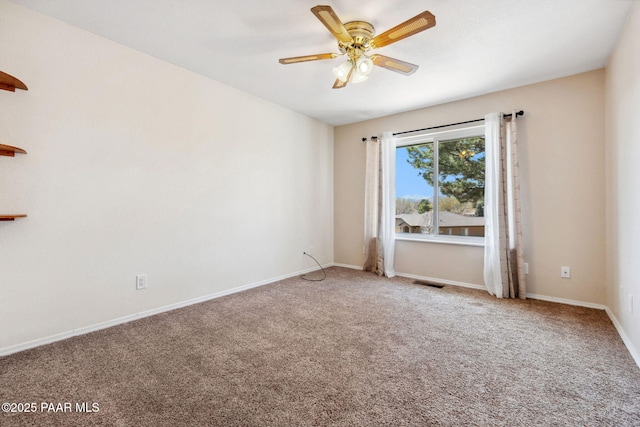 carpeted empty room with a ceiling fan, baseboards, and visible vents