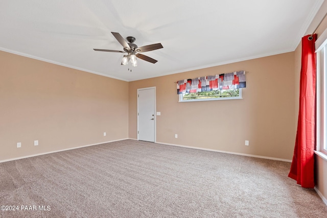 spare room featuring baseboards, a ceiling fan, ornamental molding, and carpet flooring