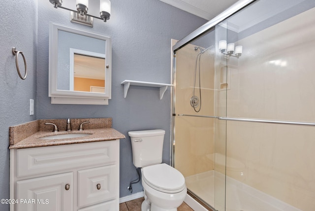 full bath featuring toilet, a stall shower, vanity, and a textured wall