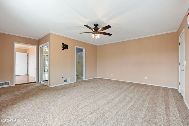 unfurnished room with crown molding, light colored carpet, and visible vents