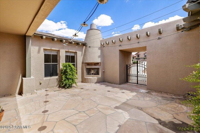 5560 W Halcyone Cir, Prescott, AZ 86305 - rear view of house with stucco siding and a patio