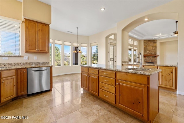 5560 W Halcyone Cir, Prescott, AZ 86305 - kitchen featuring light stone counters, a ceiling fan, a sink, a stone fireplace, and dishwasher