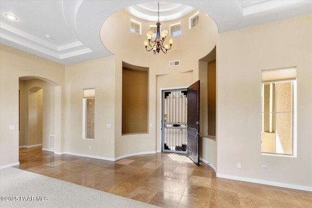 5560 W Halcyone Cir, Prescott, AZ 86305 - entrance foyer featuring a tray ceiling, a towering ceiling, visible vents, and baseboards