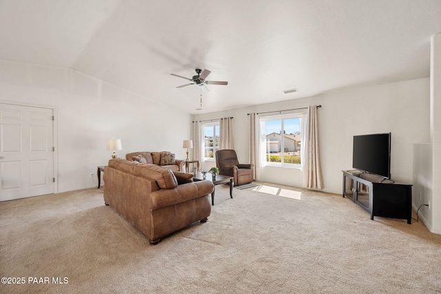 carpeted living area featuring a ceiling fan, lofted ceiling, and visible vents