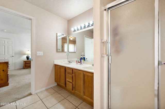 full bathroom featuring tile patterned flooring, a sink, and a shower stall