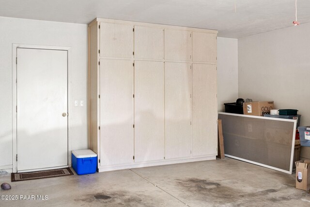 interior space with a closet and unfinished concrete floors