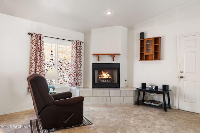 living area featuring a lit fireplace, carpet flooring, and recessed lighting