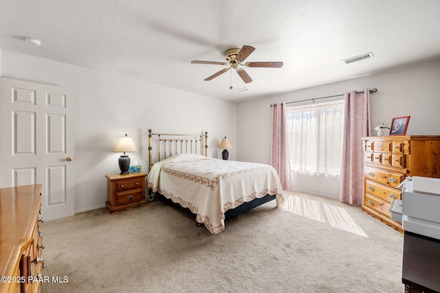 carpeted bedroom featuring visible vents and ceiling fan