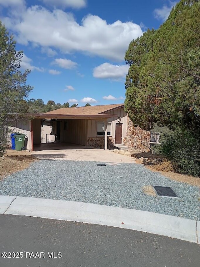 550 Eastwood Pl, Prescott, AZ 86303 - view of front of house featuring board and batten siding, an attached carport, and gravel driveway