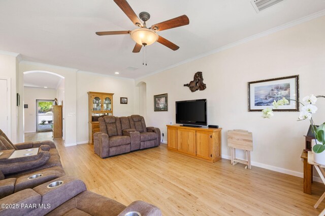7812 E Rusty Spur Trl, Prescott Valley, AZ 86315 - living room with arched walkways, light wood finished floors, ceiling fan, crown molding, and baseboards