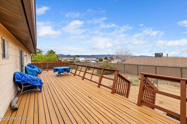 wooden terrace with a mountain view and a fenced backyard