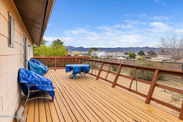 wooden terrace featuring a fenced backyard and a mountain view