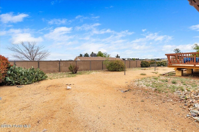 view of yard featuring fence and a wooden deck