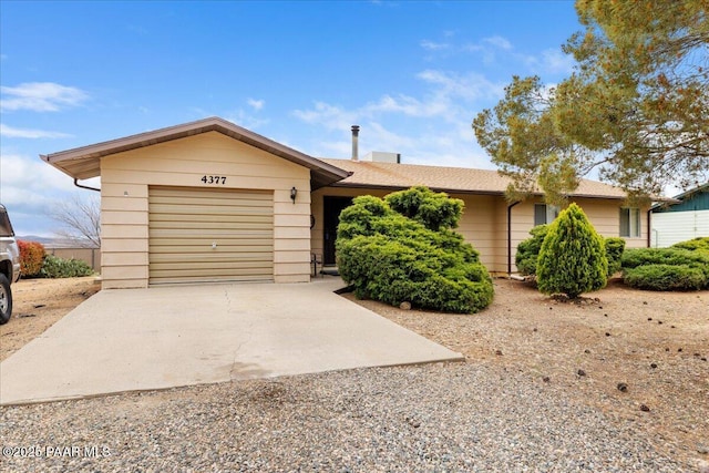 ranch-style home with an attached garage and driveway