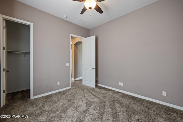 unfurnished bedroom featuring visible vents, ceiling fan, baseboards, carpet flooring, and a closet