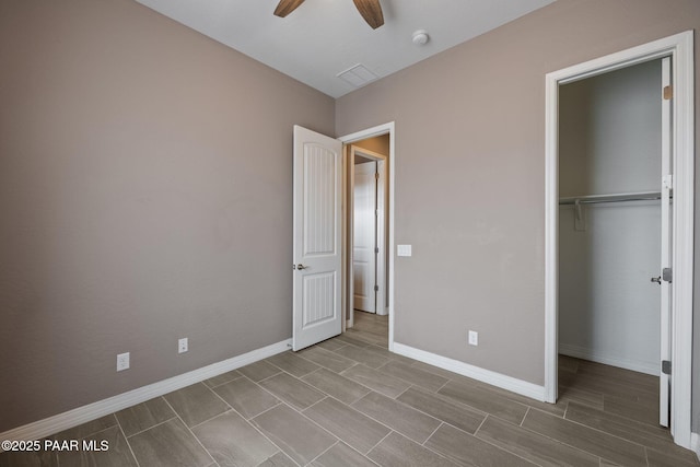 unfurnished bedroom with wood finish floors, baseboards, a closet, and ceiling fan