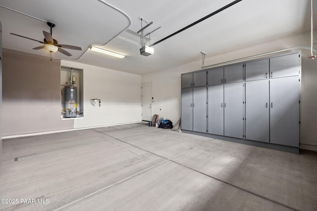 garage with a garage door opener, a ceiling fan, and water heater