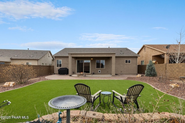 back of property with stucco siding, a patio, a lawn, and a fenced backyard