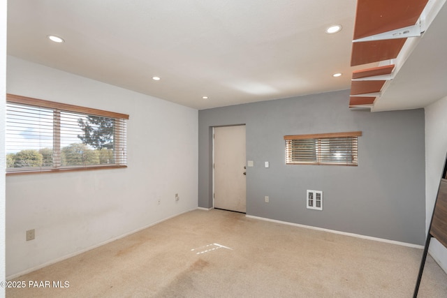 unfurnished room featuring light colored carpet