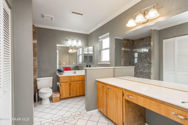 bathroom with tile patterned flooring, vanity, tiled shower, and crown molding