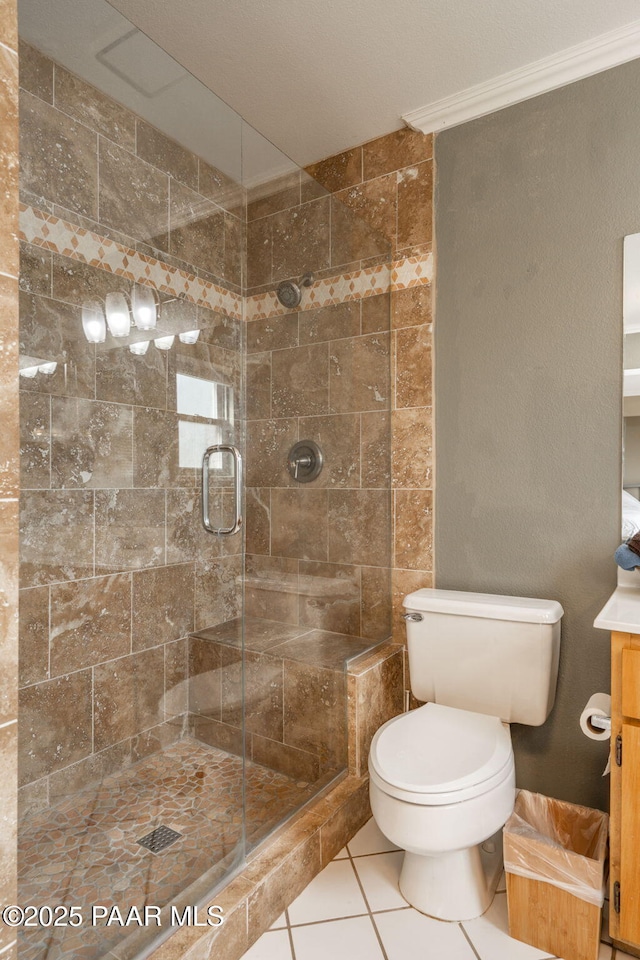 bathroom featuring an enclosed shower, vanity, tile patterned floors, and toilet