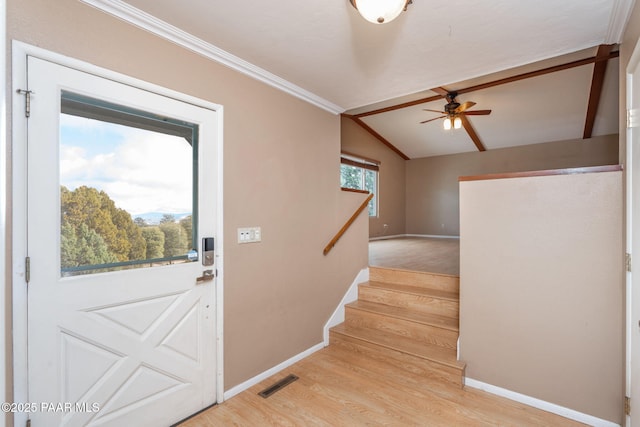 entryway with ceiling fan, lofted ceiling, light hardwood / wood-style flooring, and ornamental molding