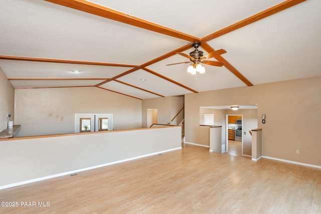 unfurnished living room featuring ceiling fan, lofted ceiling with beams, and light wood-type flooring