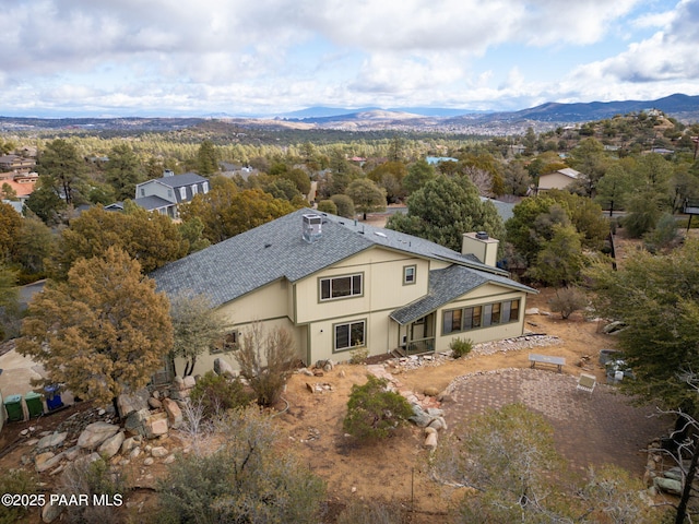 rear view of property featuring a mountain view