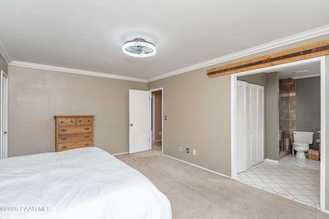 bedroom with crown molding, light colored carpet, and ensuite bath